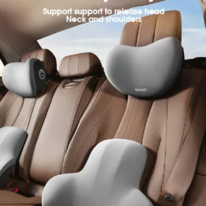 A black memory foam car neck pillow and lumbar support combo attached to a car headrest.